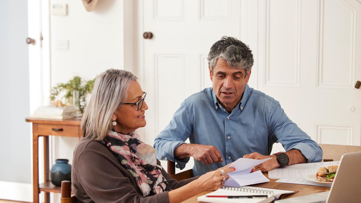 Older man and woman looking at documents at a table
