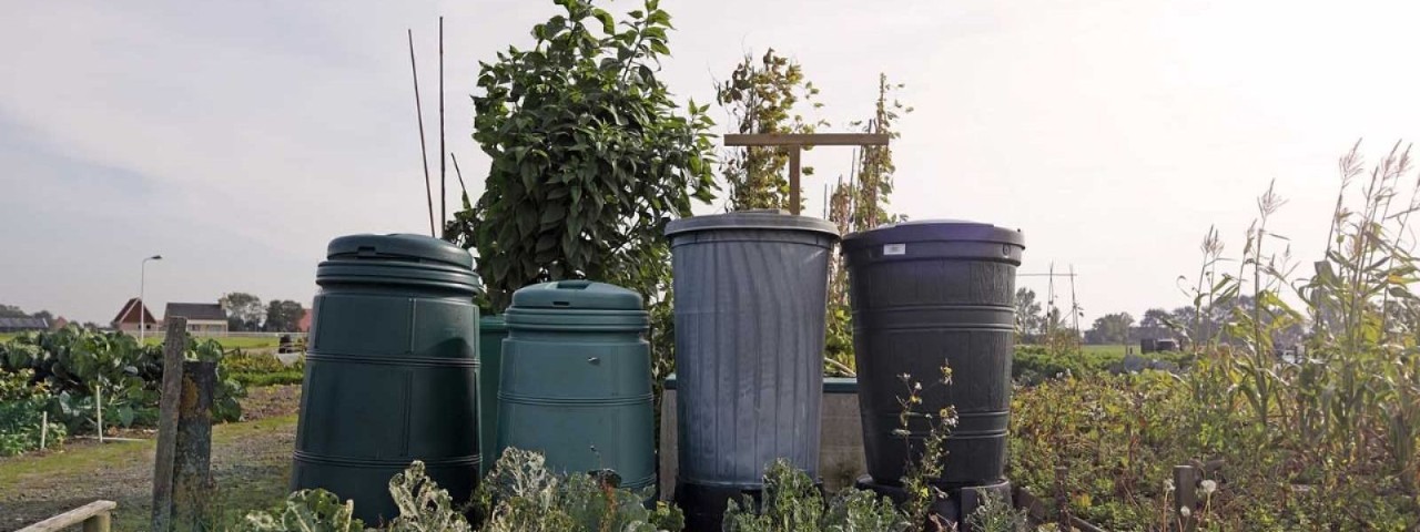 four compost bins in a garden