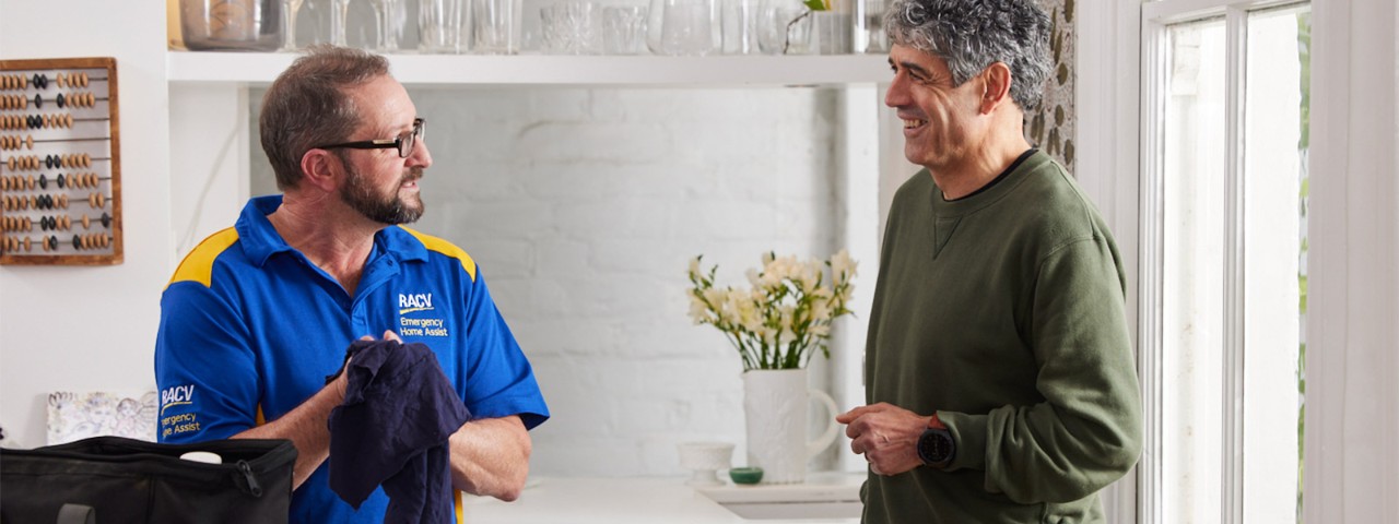 RACV Plumber talking to a customer in their home
