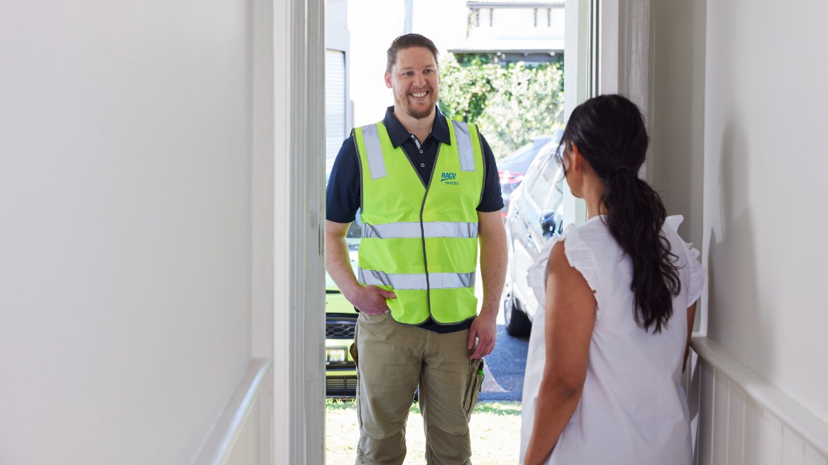 RACV tradie standing in doorway talking to homeowner