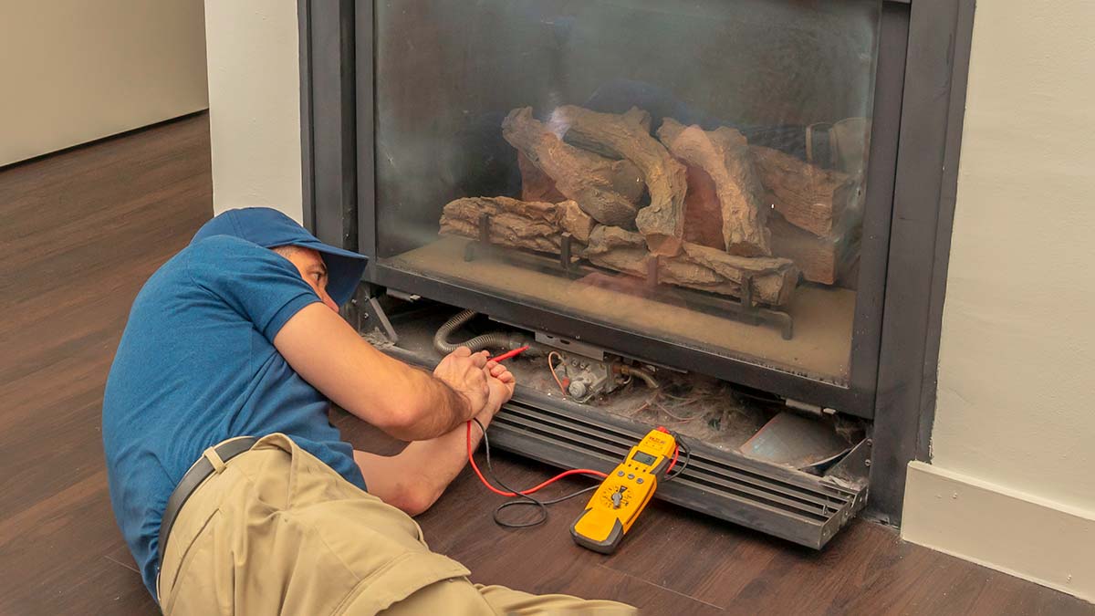 Tradesperson fixing heater