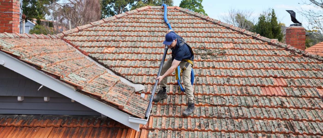 RACV tradie cleaning rooftop gutters