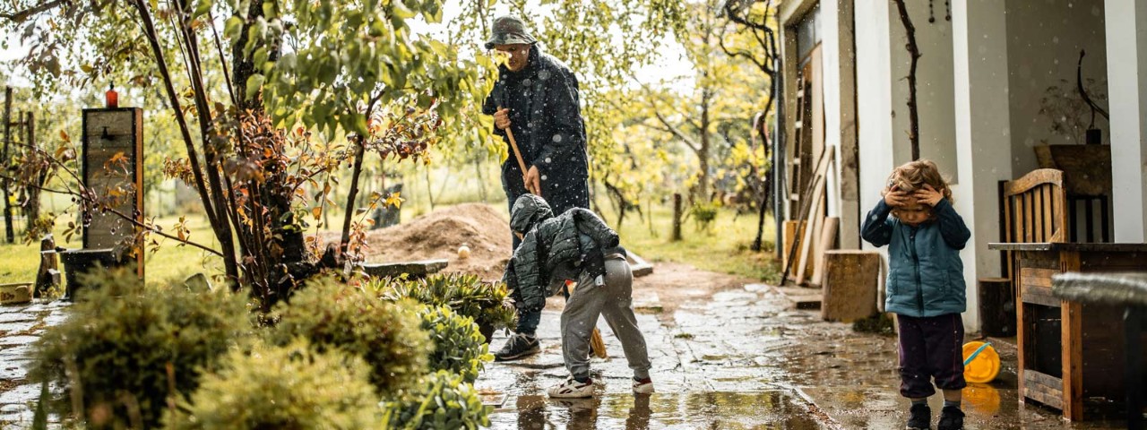 1224471637 Family cleaning outside house from rain damage Getty