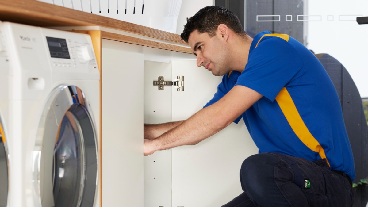 RACV plumber fixing laundry pipe