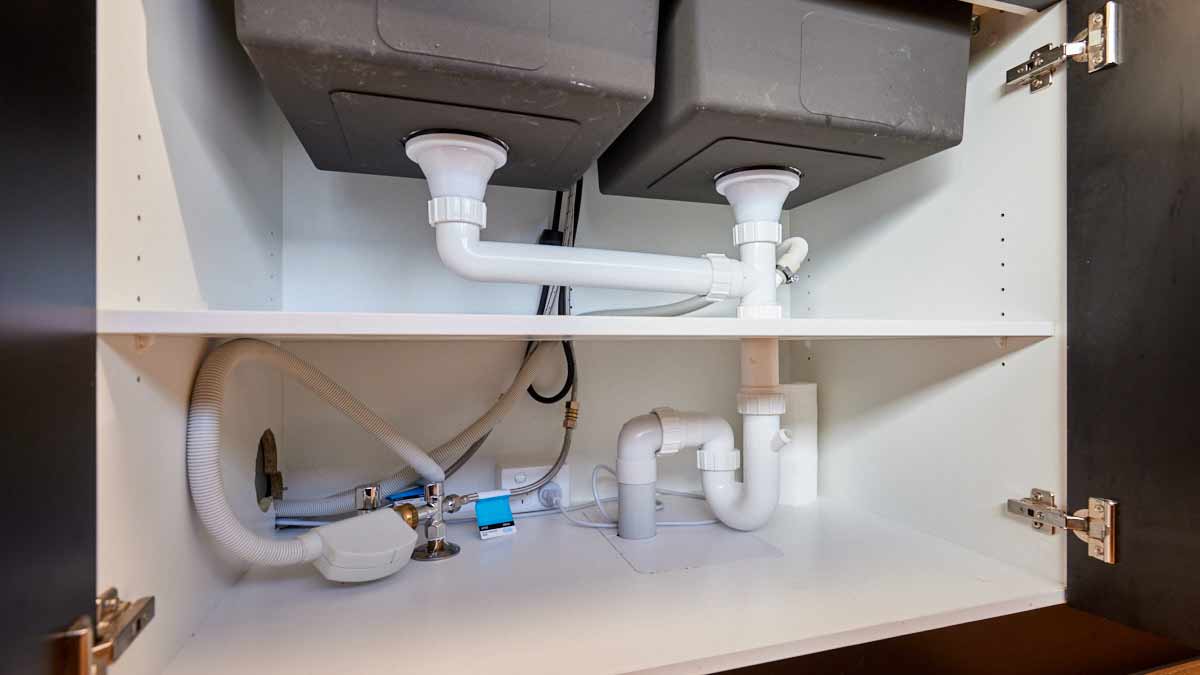 view under sink of plumbing