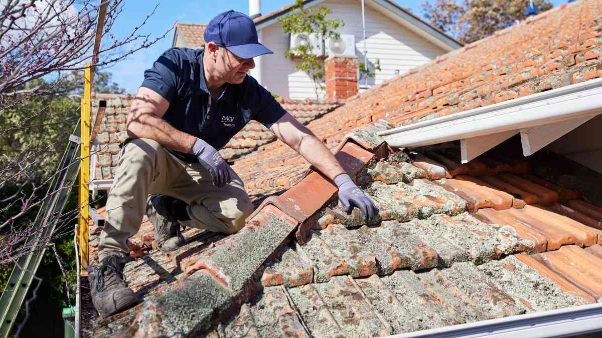 RACV tradie examining roof tiles