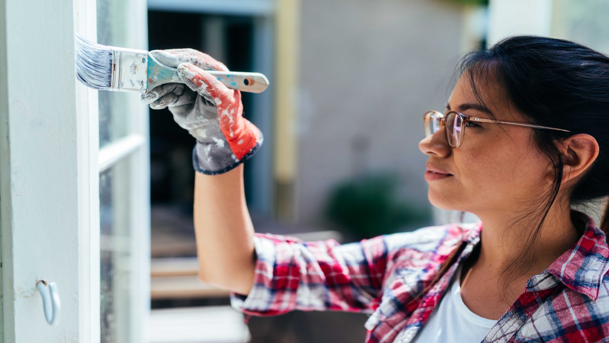 Woman painting a wall