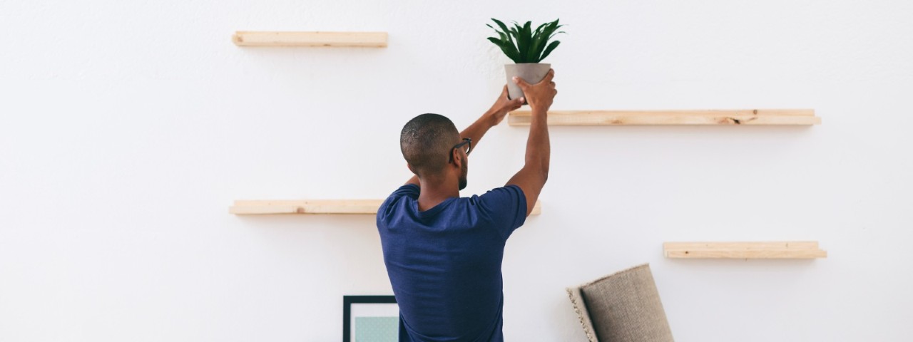 Man organising his shelves