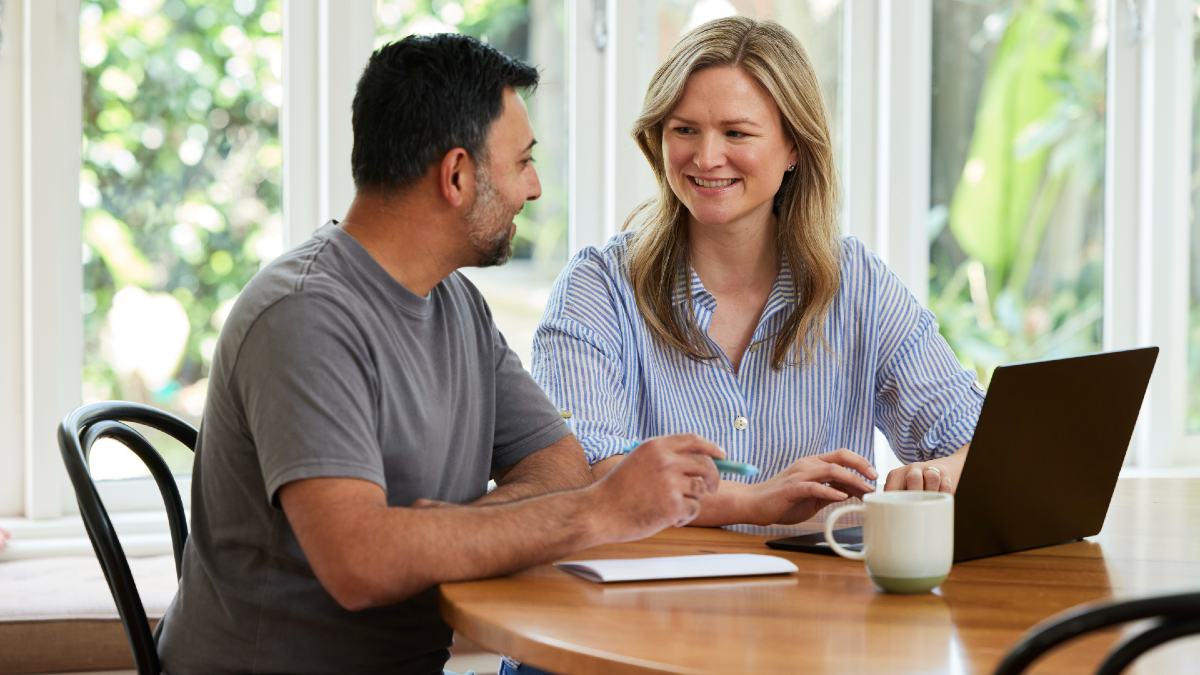 man and woman looking at laptop together