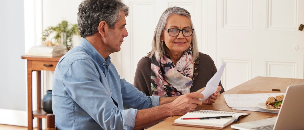 Rental provider Two older people discuss documents
