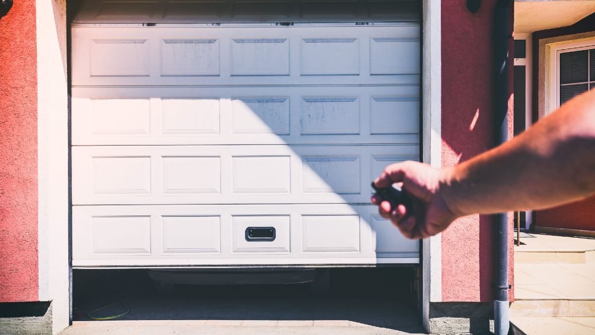man unlocking garage door with a key fob