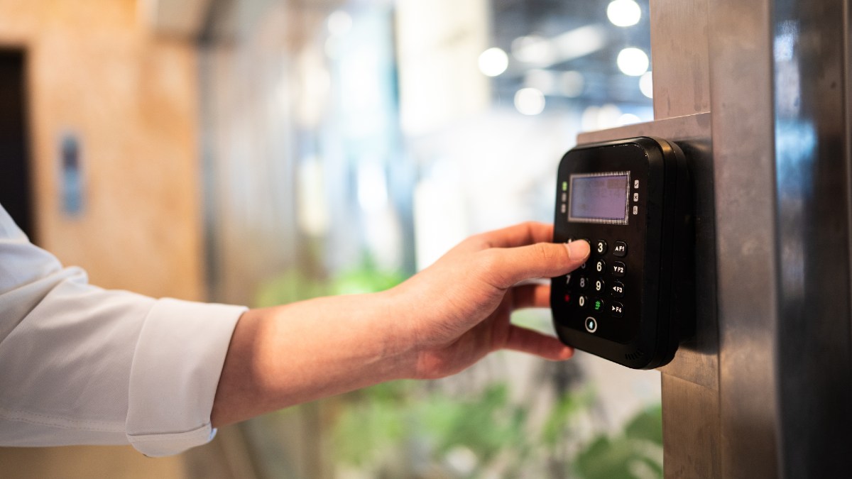 woman unlocking a digital lock with keypad