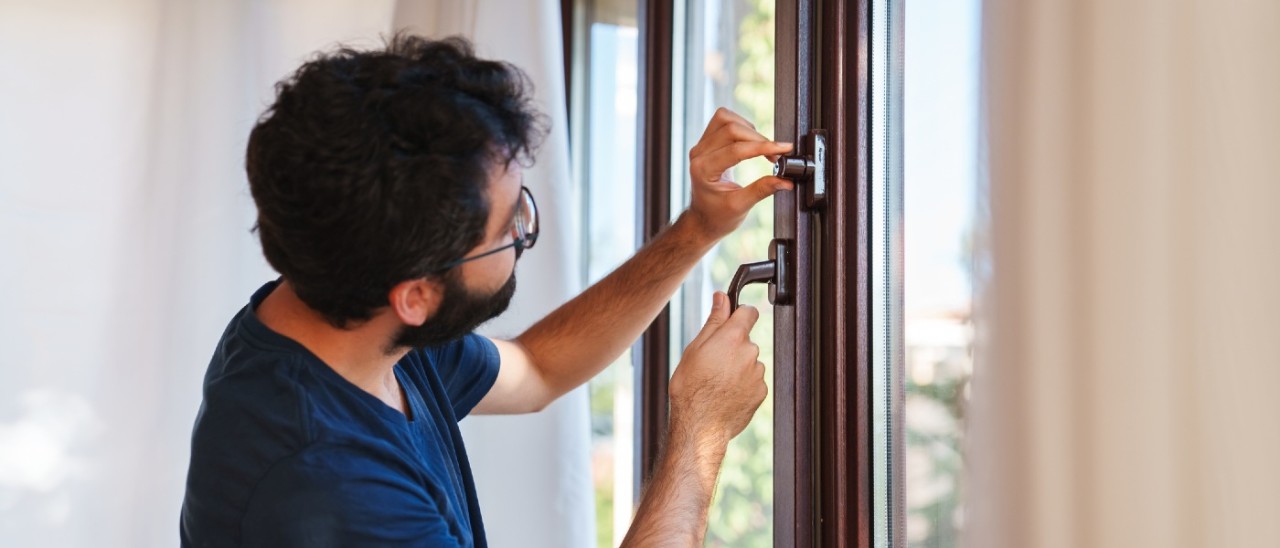 A man locking a window