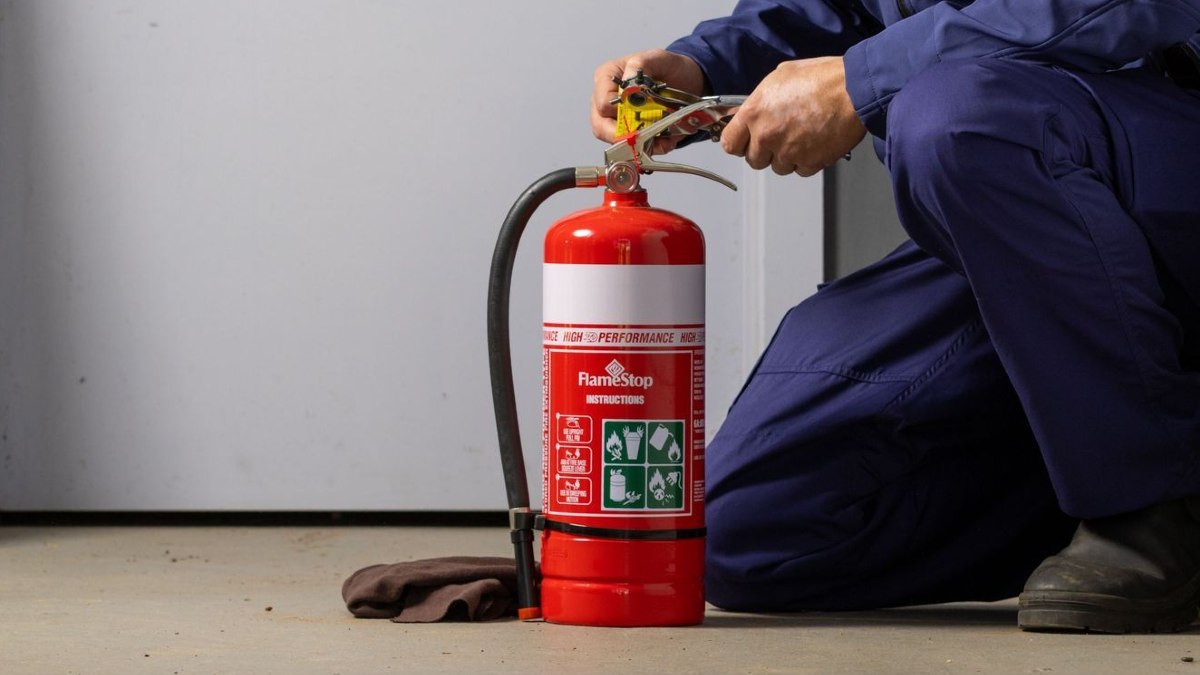A person demonstrating how to use a fire extinguisher