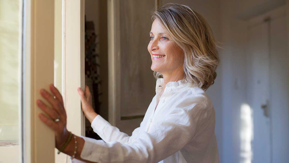 woman closing window