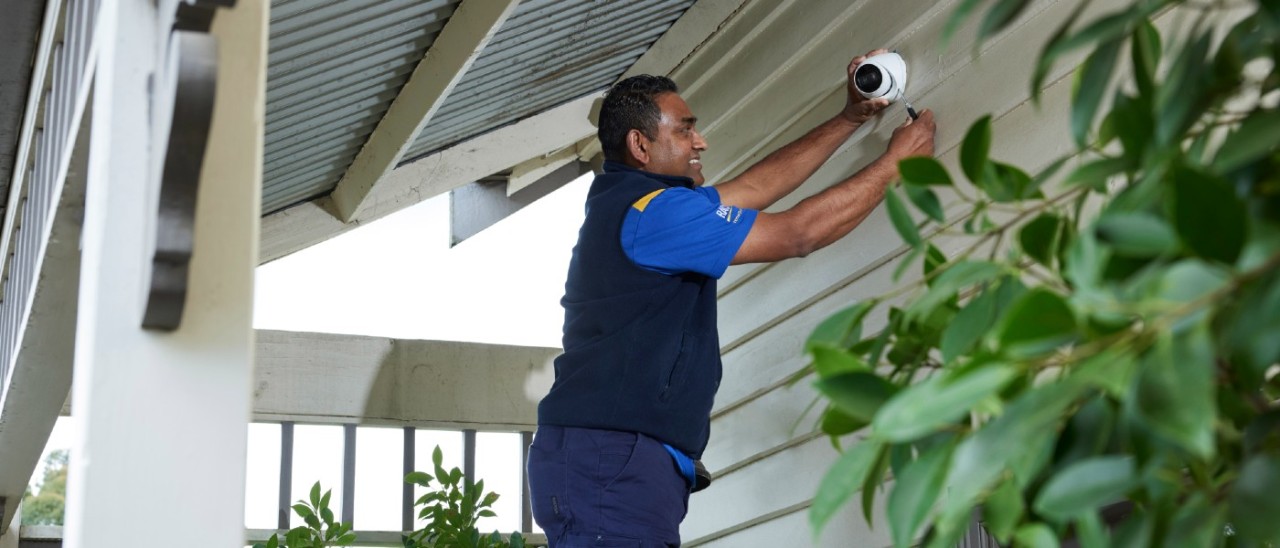 RACV technician installing a CCTV camera
