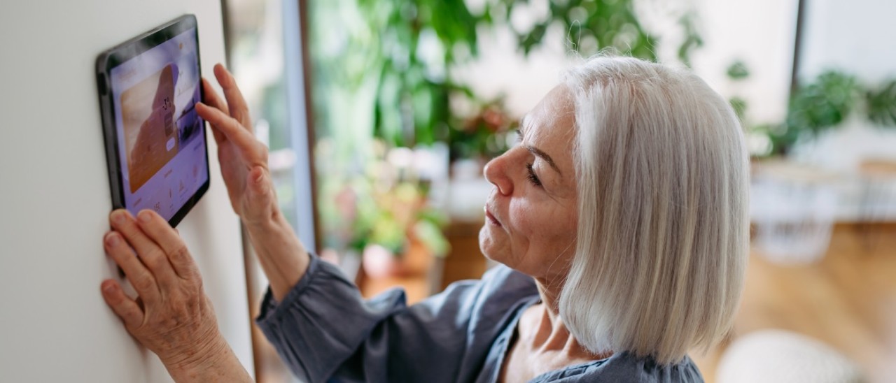 senior woman adjusting her home connectivity screen