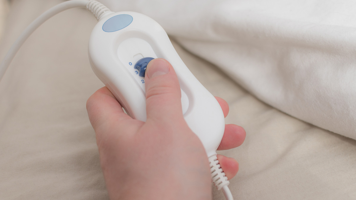 A person with a electric blanket controller