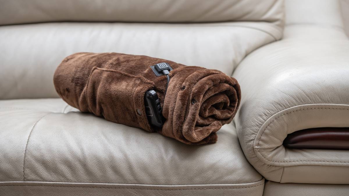 brown electric blanket rolled up on couch