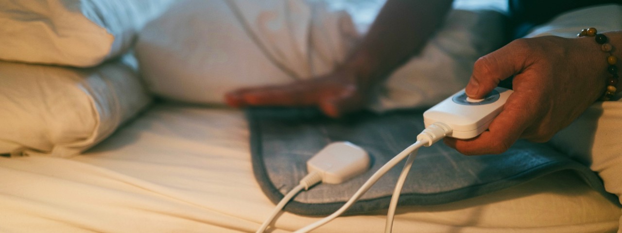 A person using an electric blanket controller