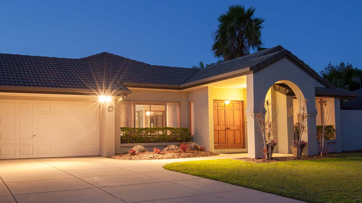 House with flood lights above garage and porch at front of house.