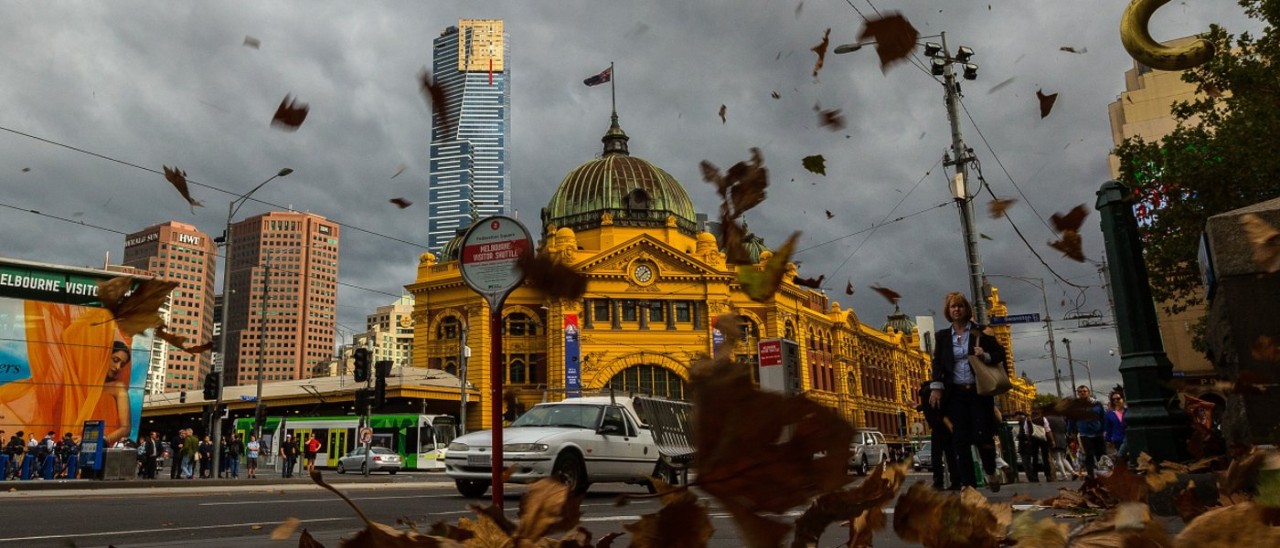 Wind in melbourne Flinders Street Station on a windy, stormy day with leaves blowing in the air