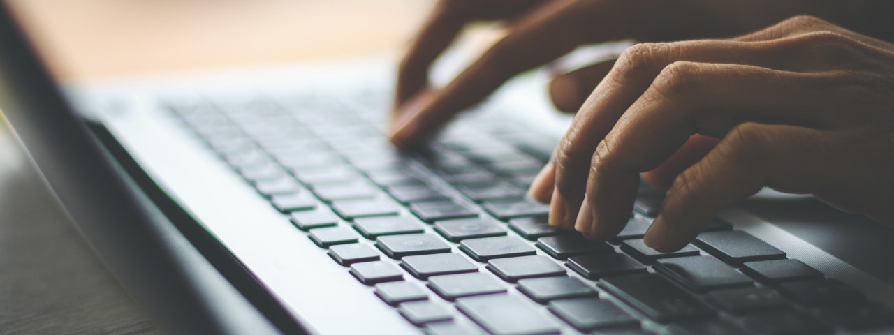 person typing on keyboard