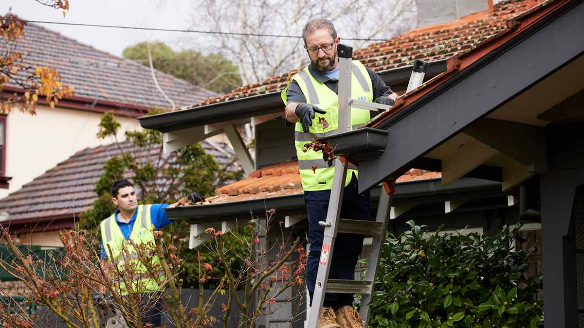 man cleaning gutters