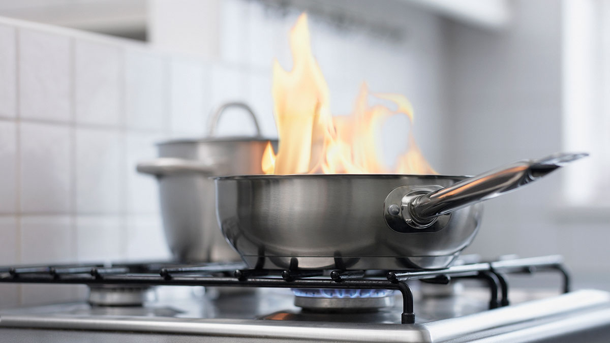pan on stove with flames