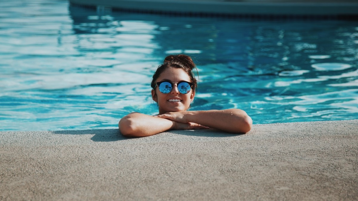 child hanging out in pool