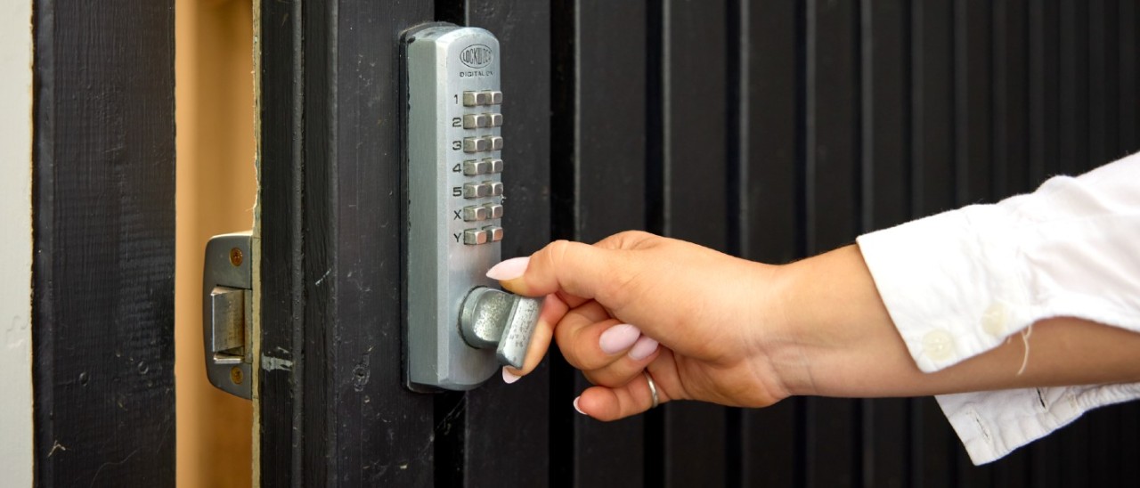 Door Keypad Lock_RACV woman opening a door with a deadbolt keypad lock
