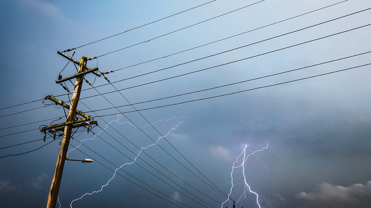Powerlines and storm clouds with lightning