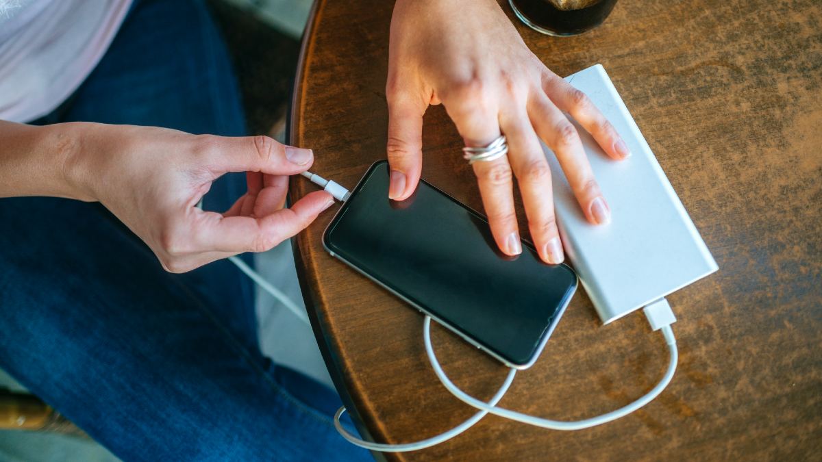 woman charging her smartphone with a powerbank