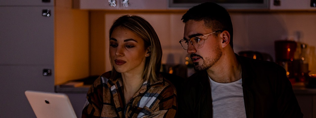 1455224108 couple looking at computer during blackout