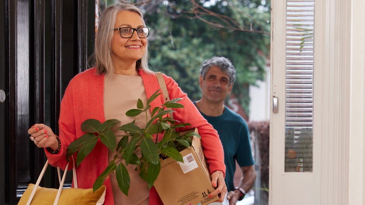 two senior people moving in to their new home