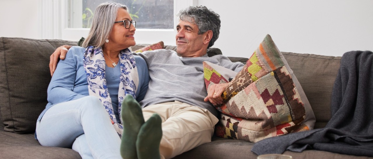 Seniors Downsizing Home_RACV senior couple relaxing on couch