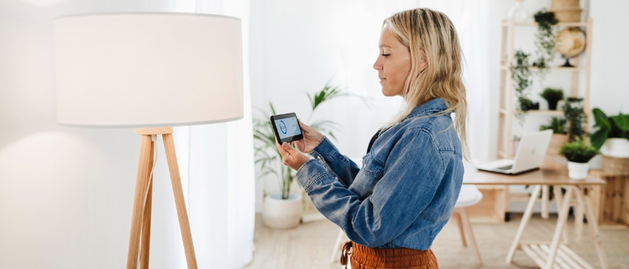 woman checking her household energy use in a smartphone app