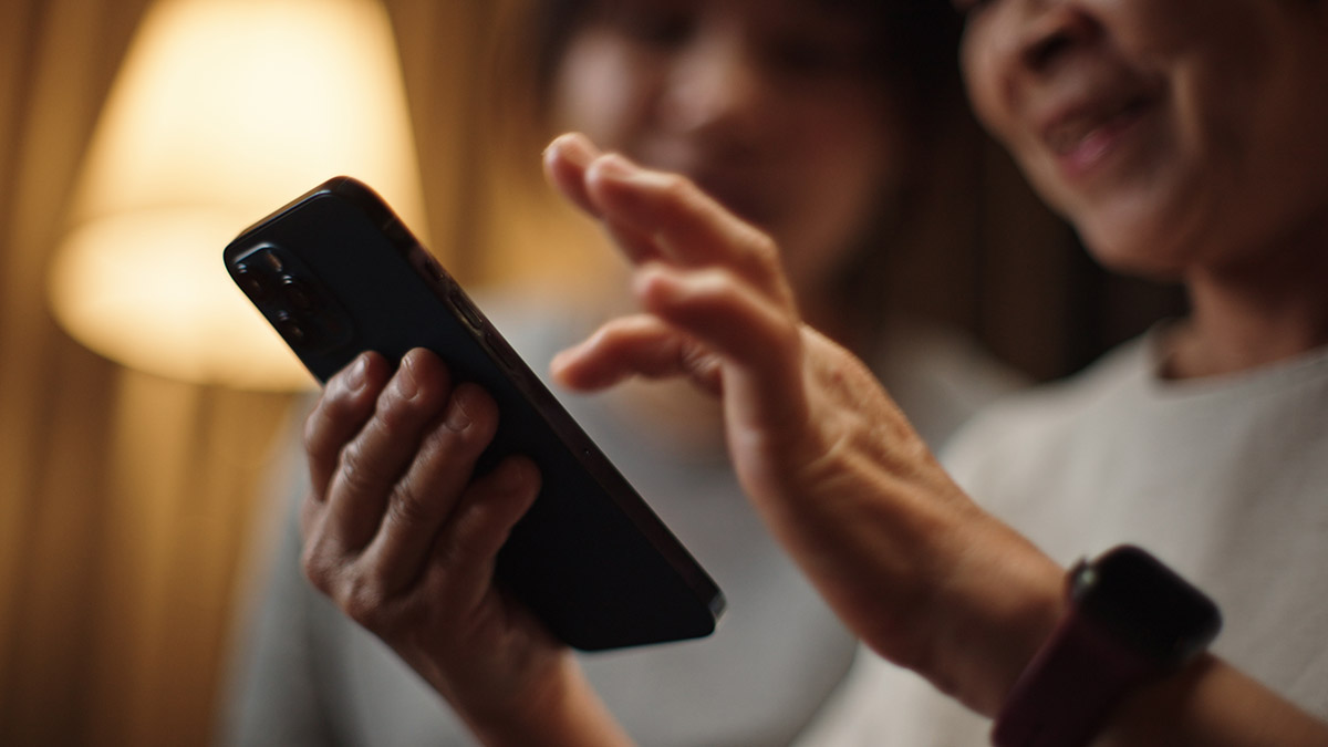Woman using phone app to control lighting at home