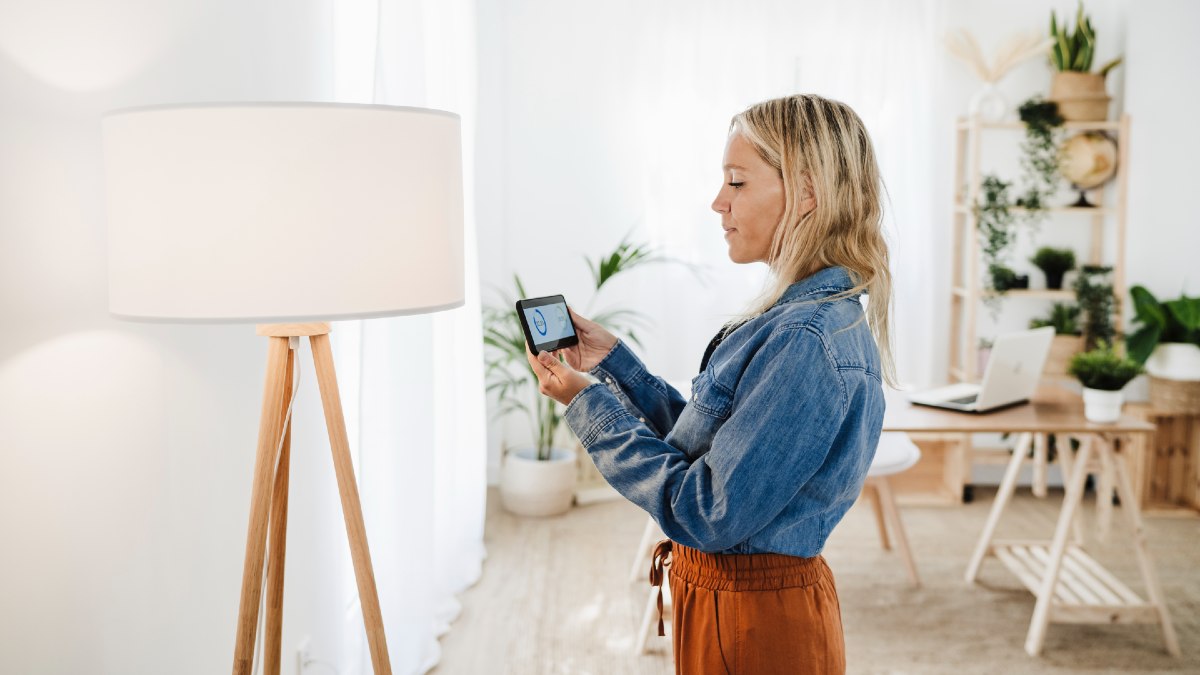 woman checking her household energy use in a smartphone app