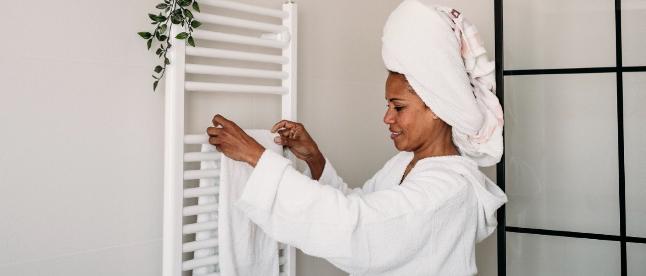 Heated towel rail Mother drying child with towel after a bath