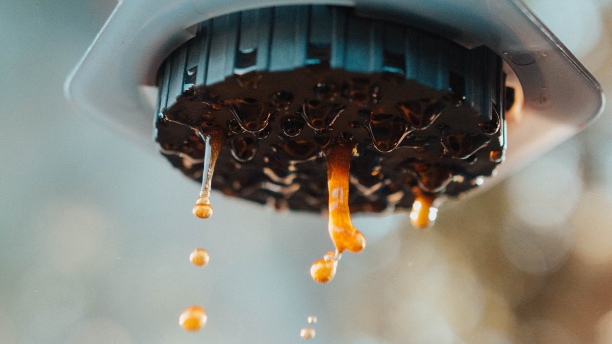 close up image of fresh coffee coming out of aeropress machine