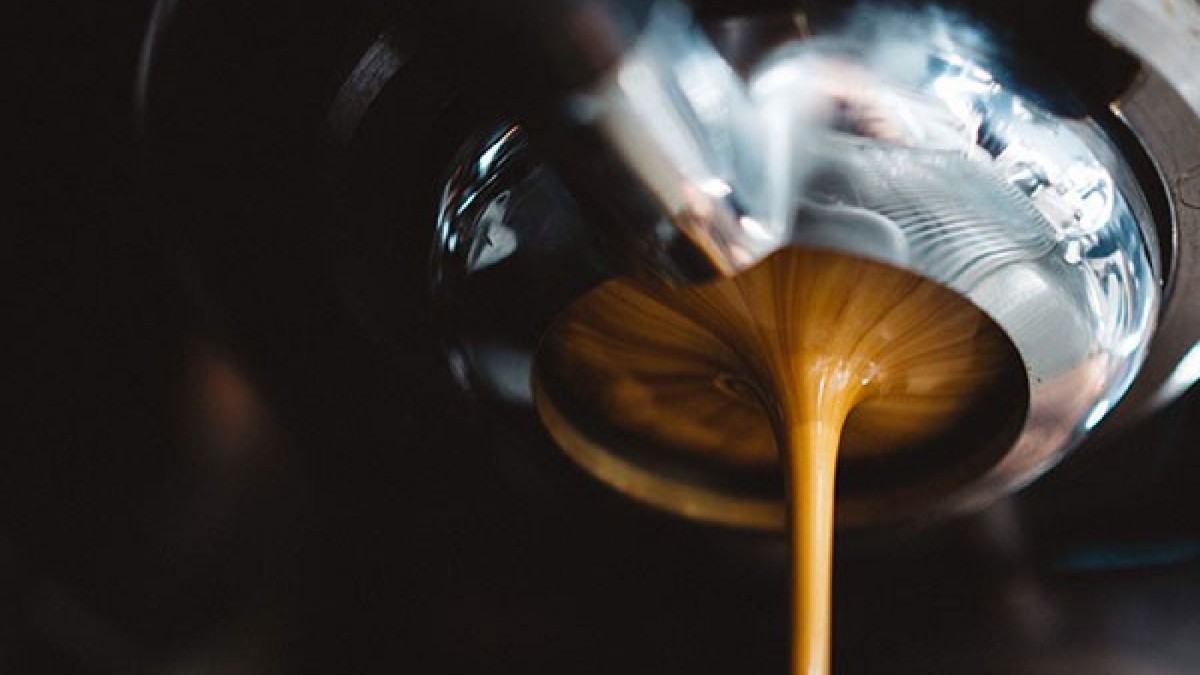 fresh espresso coming out of espresso machine head