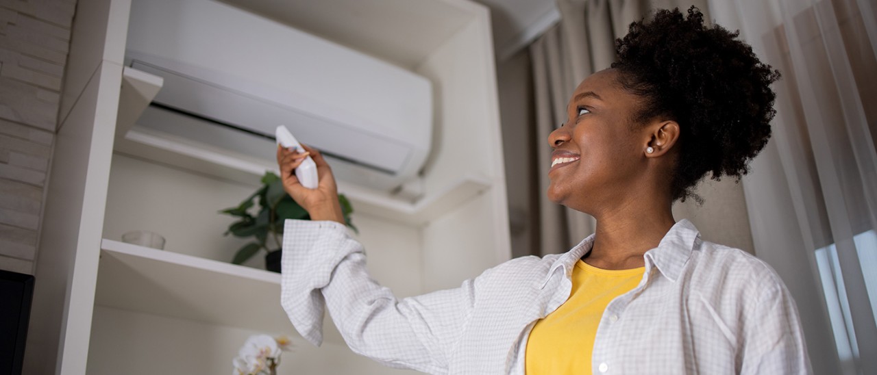 woman in front of air conditioner