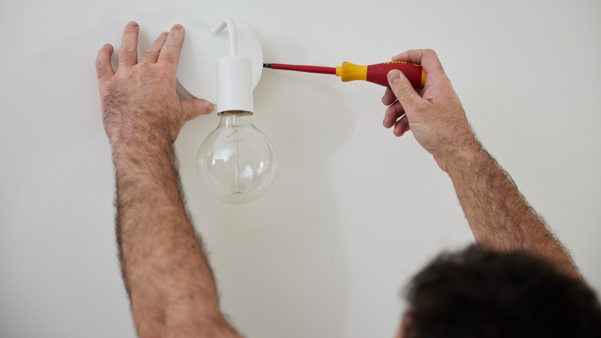 RACV electrician changing light fixture