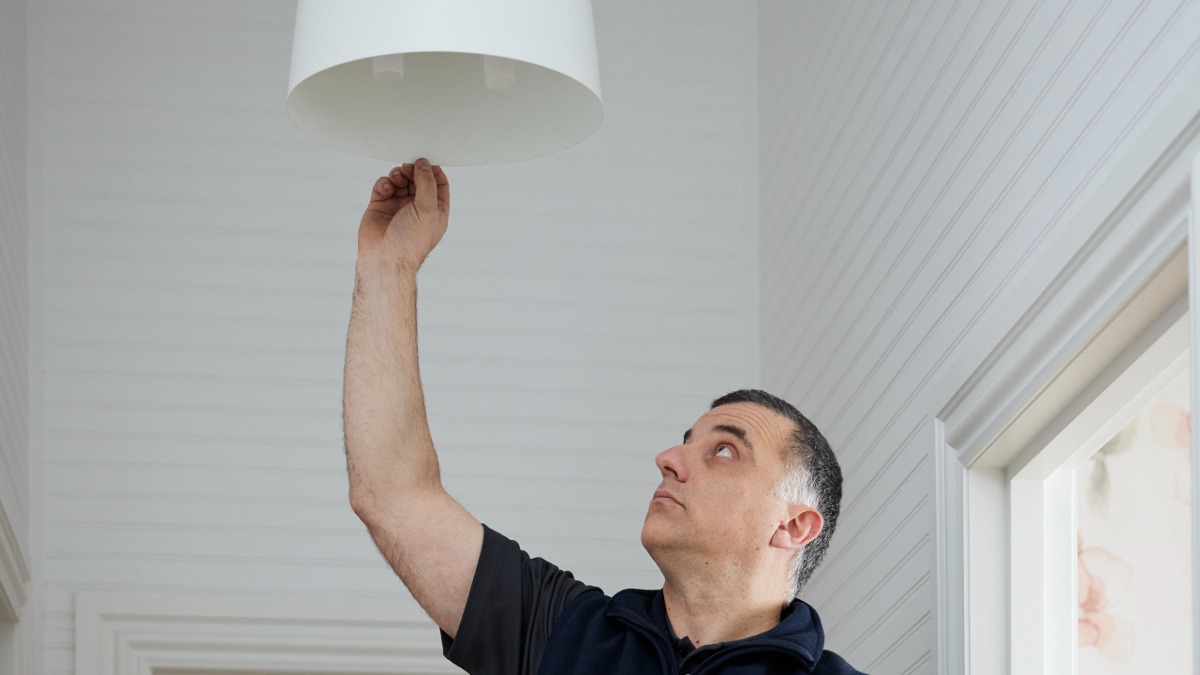 RACV electrician changing lightbulb