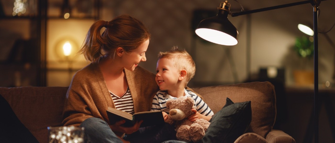 Lightbulb_RACV woman and child reading a book on couch under a lamp