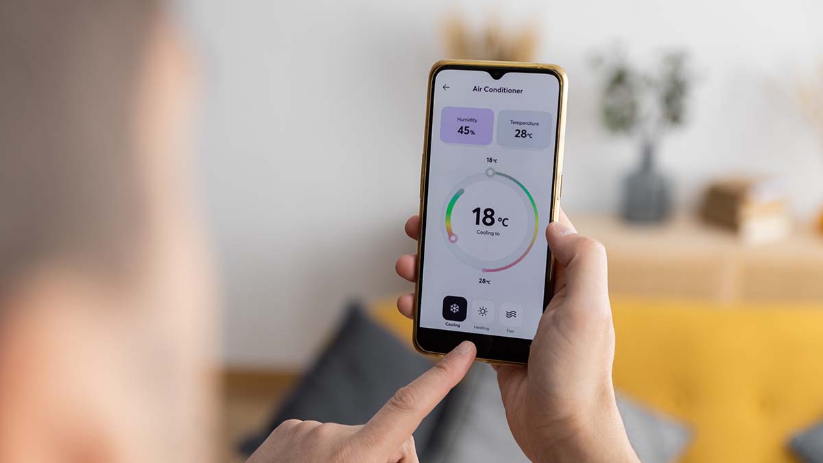 person using smartphone to turn on air conditioner