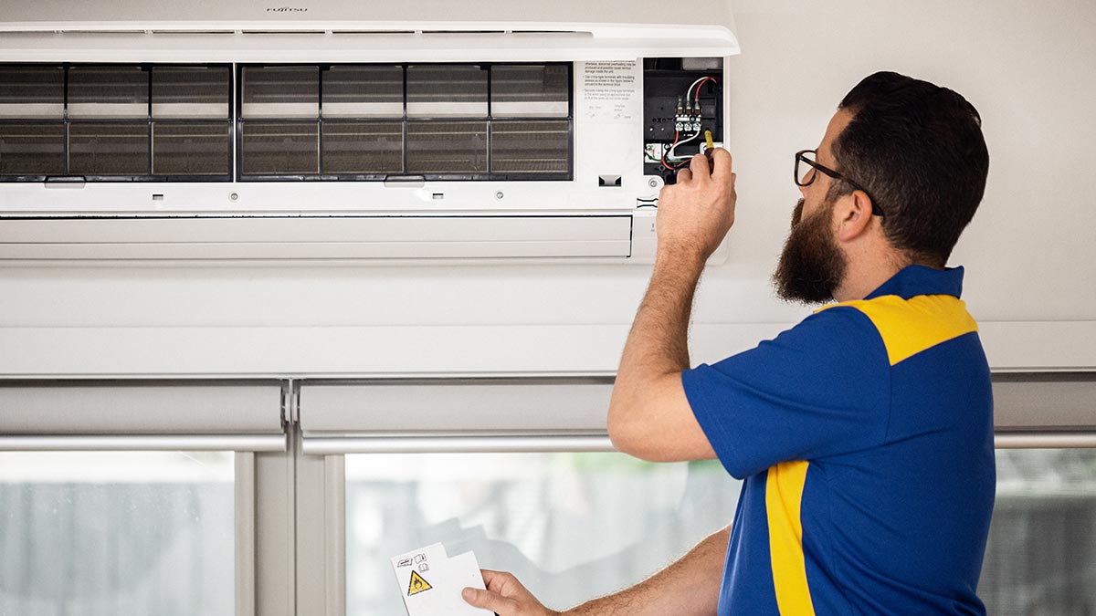 Qualified tradesperson fixing split system air conditioner