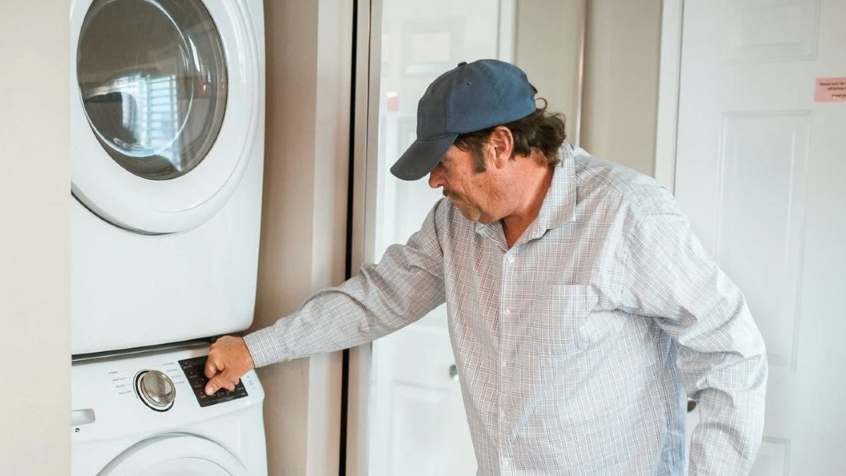 man turning on clothes dryer