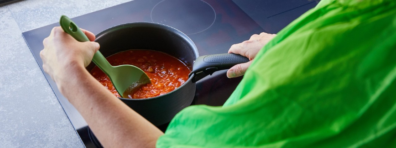 woman cooking on an induction cooktop